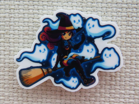 First view of Witch riding a broomstick with kitty ghosts flying around her minder.