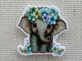 First view of Baby elephant with beautiful flowers minder.