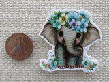 Second view of Baby elephant with beautiful flowers minder.
