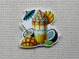 First view of Blue Umbrella Tropical Drink Needle Minder with sliced mangos, coconuts and drizzled in yummy goo.
