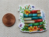 Second  view of a colorful stack of six books with yellow flowers and pretty leaves minder.