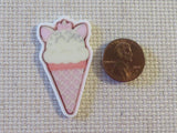 Second view of Ice cream cone in the shape of a white cat with pink ears and a bow minder.