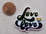 Second view of The words "Love is Love" with a small rainbow heart minder.