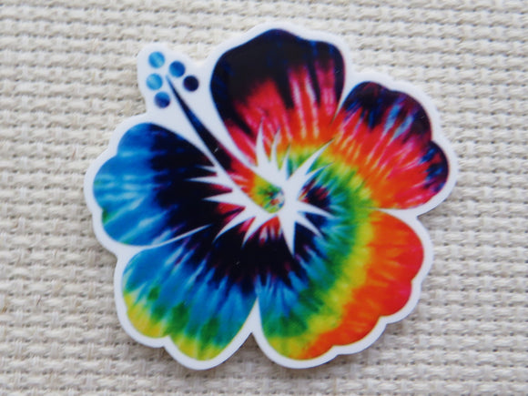 First view of Beautiful tropical flower with a tie dye rainbow look minder.