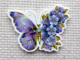 Minder of a purple butterfly with floral details on half the wings.