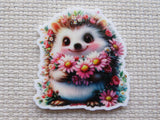 Floral hedgehog holding pink daisies minder.