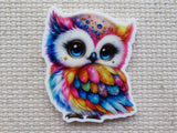 First view of rainbow colored bedazzled owl minder.