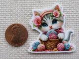 Second view of a cute cat with balls of yarn minder.