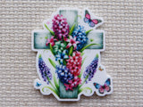 Elegant cross with colorful flowers and fluttering butterflies minder.