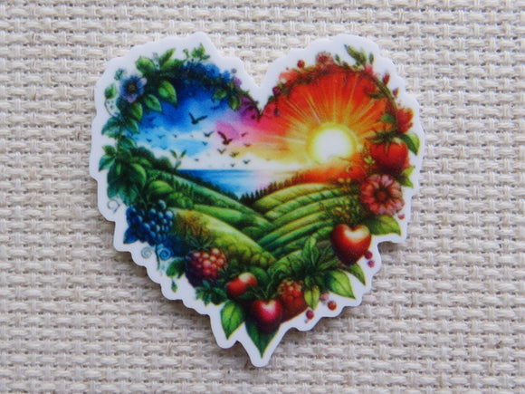 Heart-shaped minder with a colorful landscape design.