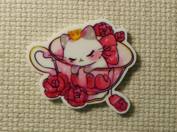 First view of sleepy kitty in a pink cup Needle Minder.
