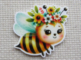 Colorful bee-shaped minder with floral crown.