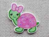 Minder of a cartoon turtle with a pink shell and bow on a textured background