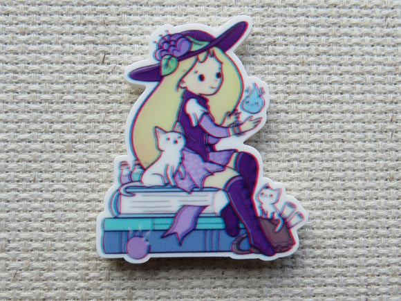 First view of Girl Sitting on Books Needle Minder.