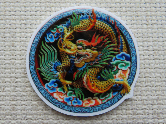 First view of Gold Colored Dragon in a Blue Circle Needle Minder.