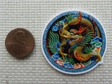 Second view of Gold Colored Dragon in a Blue Circle Needle Minder.