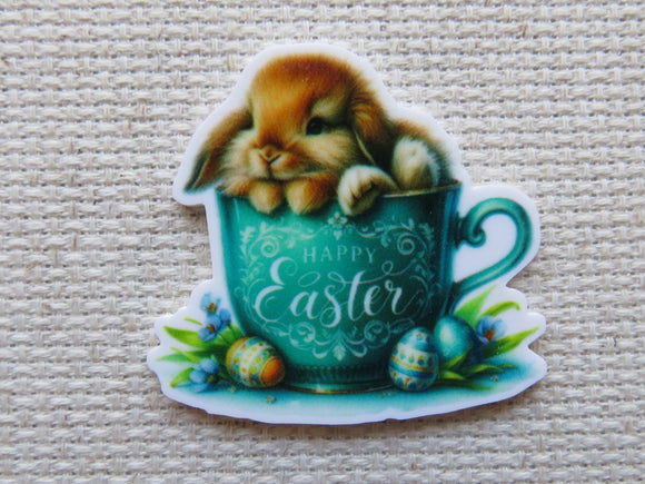 First view of Cute bunny lounging in a blue tea cup with the saying Happy Easter on it minder.