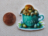 Second view of Cute bunny lounging in a blue tea cup with the saying Happy Easter on it minder.
