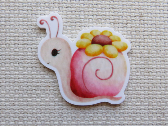 First view of Snail with a Yellow Flower Needle Minder.