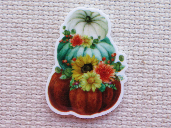 Decorative minder with pumpkins and flowers on a textured surface