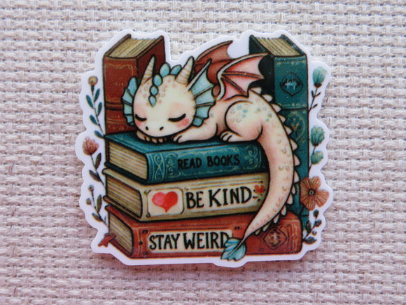 Minder with a dragon sitting on books with motivational phrases on a textured background