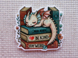 Minder with a dragon sitting on books with motivational phrases on a textured background