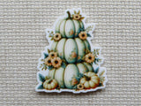 Decorative minder of stacked pumpkins with floral elements.