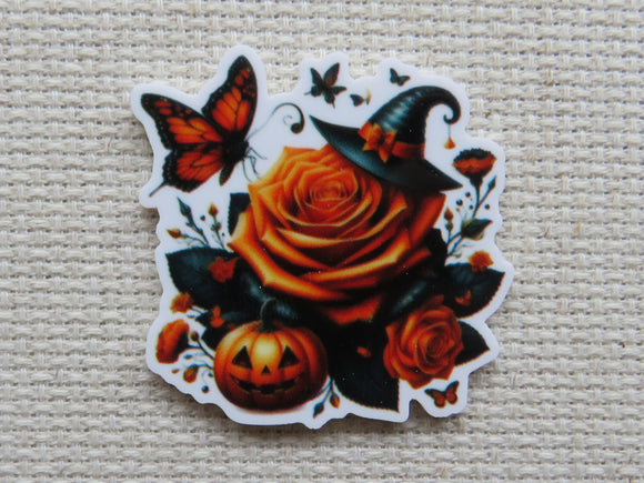 Halloween-themed minder with orange roses, pumpkins, and a witch hat