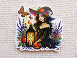 Halloween-themed minder with a witch, pumpkins, and lantern on a textured beige background