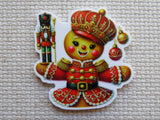 Decorative minder of a gingerbread in a red outfit with a crown on a textured beige background