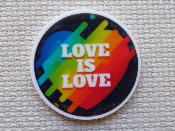 Round minder with 'Love is Love' text on a rainbow background