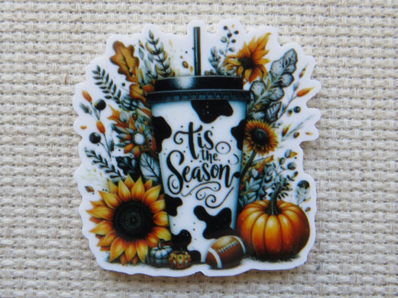 Minder with 'tis the season' text, pumpkins, and sunflowers on a textured background