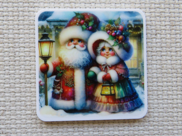 Minder with a design of Santa Claus and a woman holding a lantern on a textured surface.