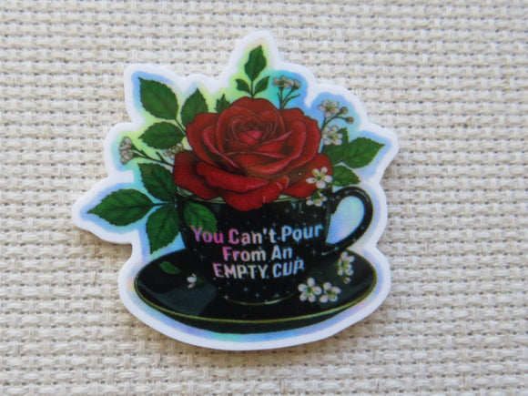 Minder with a red rose and teacup design on a textured surface