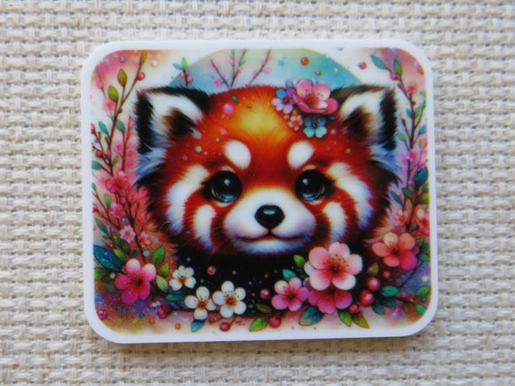 Minder with a red panda design surrounded by flowers on a textured surface