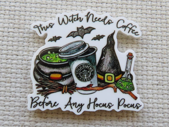 Minder with coffee cup, cauldron, and witch elements on a textured background