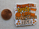 Minder with 'Pumpkin Spice and Everything Nice' text and a pumpkin graphic next to a penny for scale.
