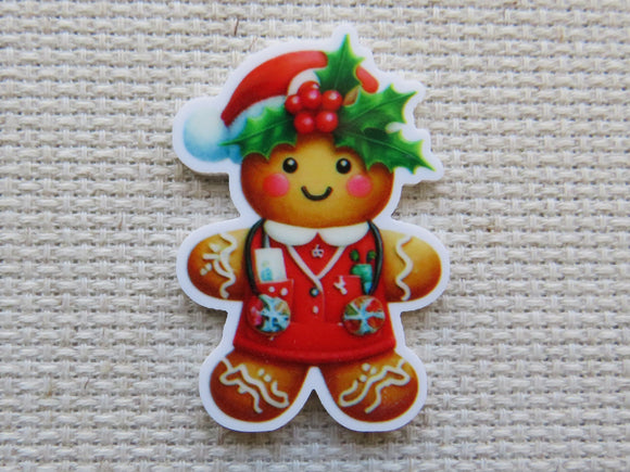 Gingerbread man minder wearing a red medical top, with holly leaves and berries adorning the red Santa hat he is wearing.
