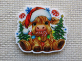Minder of a cow wearing a Santa hat with Christmas decorations on a textured surface