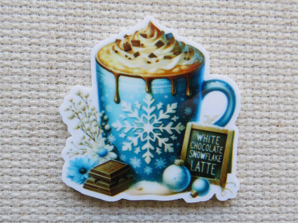 Minder of a blue mug with whipped cream and chocolate pieces on a textured beige background