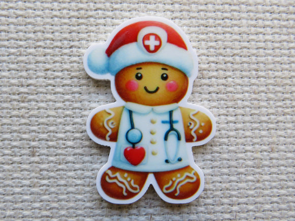 Gingerbread man minder with a doctor's outfit on a textured surface