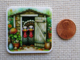 Minder with two cartoon turkeys in front of a garden shed, next to a penny for scale.