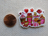 Minder with Valentine's Day-themed items next to a penny on a textured surface