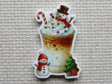 Minder of an iced coffee  with snowmen and Christmas elements on a textured surface
