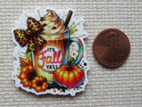 Minder with fall-themed design featuring a drink, pumpkins, and text 'It's Fall Ya'll' next to a penny for scale.