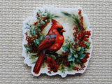 Minder of a red cardinal bird surrounded by foliage and berries on a textured surface
