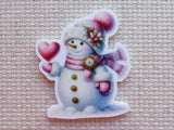 Decorative snowman minder with a pink hat and scarf on a textured surface