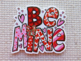 First view of "BE MINE" in red, pink and white letters minder.