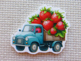 Minder of a vintage truck carrying strawberries on a textured beige background