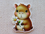 Minder of a cartoon capybara holding a flower on a textured beige background